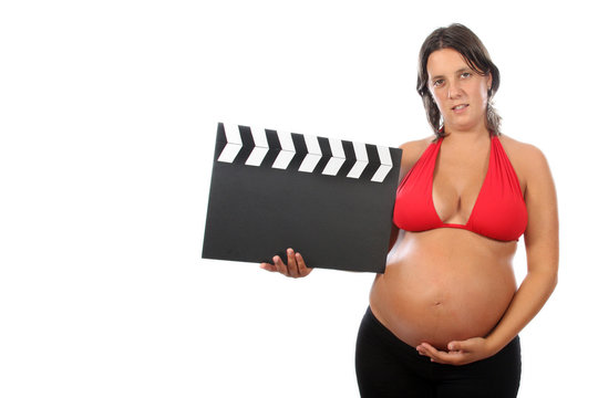 pregnant woman with beautiful belly holding movie clacket