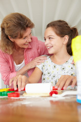 Young girl baking with grandmother