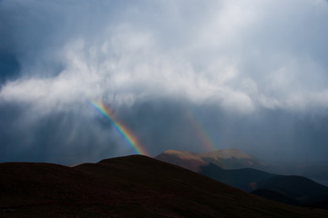What Noah Must Have Seen - A Rainbow Peeking Through the Clouds Above the Mountaintops