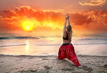 Yoga virabhadrasana warrior pose at sunset