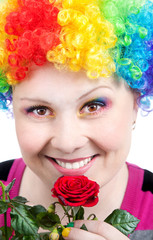 Clown with rainbow make up with rose