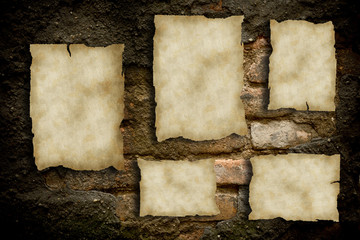 Old papers on a brick wall