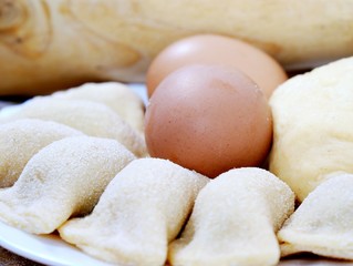 preparing of pelmeni - eggs and meatballs in dough