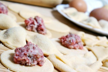 preparing of pelmeni - eggs and meatballs in dough