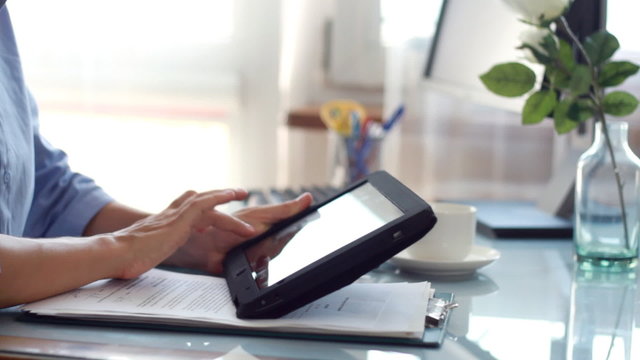 Businesswoman hands working on tablet computer