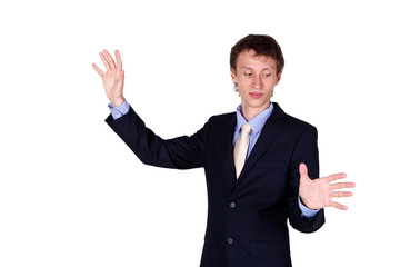 Business man in studio like touching a wall