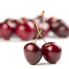 Red ripe cherries over white background