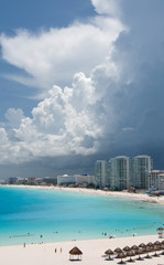 Storm clouds cover towers of a resort near Punta Cancun