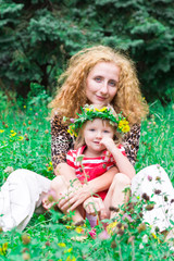 Beautiful girl with mother in the meadow