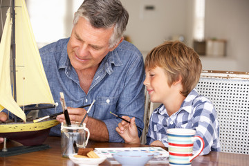 Senior man model making with grandson