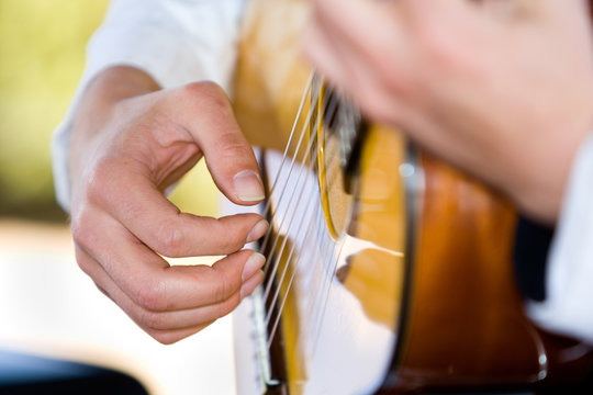 Close up of someone playing guitar