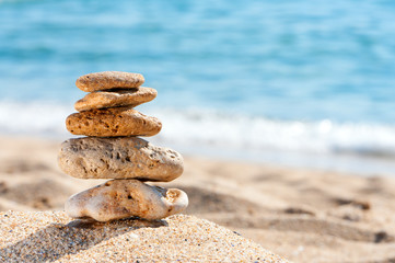 Fototapeta na wymiar Stone tower in sand against sea.
