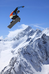Naklejka na ściany i meble Snowboarder, skok w wysokich górach
