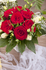 flower bouquet with red and white roses on a table.