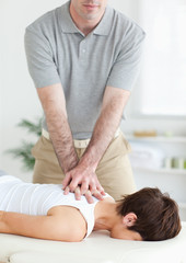 Obraz na płótnie Canvas Handsome Man massaging a cute woman's neck