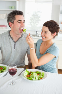 Woman feeding her boyfriend