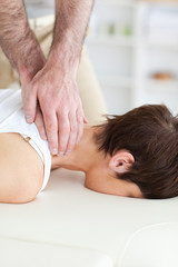 Fototapeta na wymiar Female customer's neck massaged by masseur