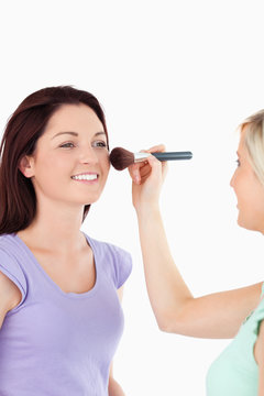 Gorgeous Women applying make-up