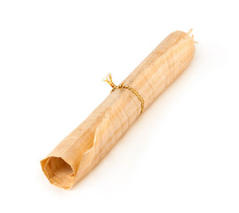 old papyrus scroll in roll with ribbon isolated on white