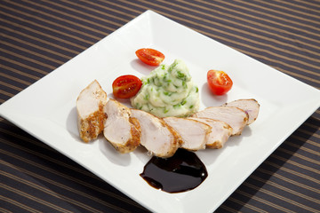 Pork tenderloin w potato puree with young peas