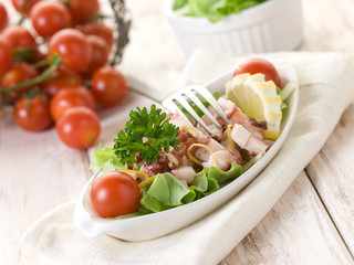 octopus salad with tomatoes and lettuce