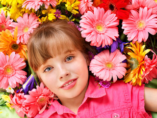 Child lying  on the flowers.