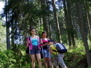 smiling kids hiking in the forest