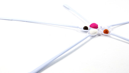 Pills spoon shot on white background.