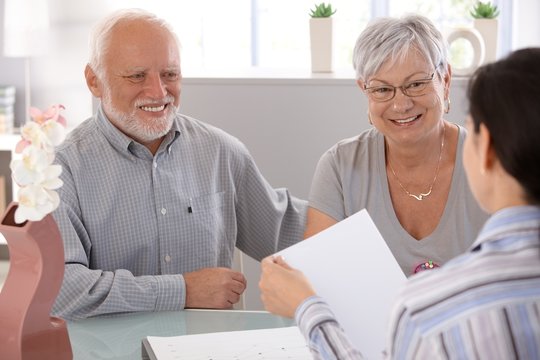 Senior couple at financial advisor smiling