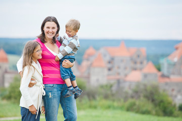Fototapeta premium Travelers. Young mother with her two children