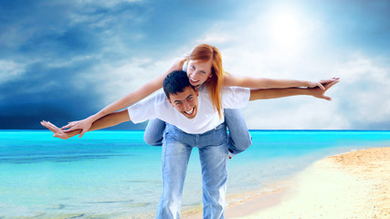 Beautiful couple on the sunny tropical beach