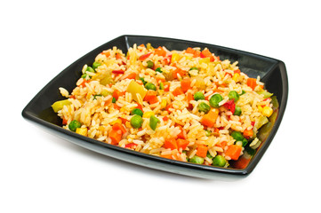 Black square plate with salad from rice and vegetables