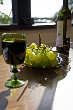 Green grapes with glass of vine