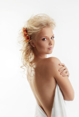 Obraz premium Beauty naked woman with flower in blond hair