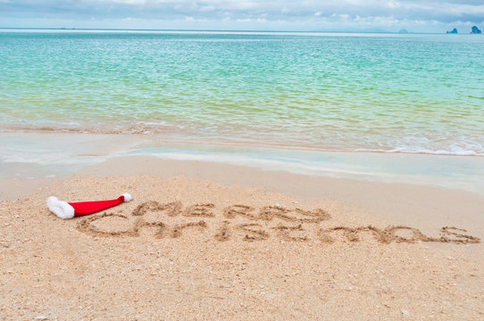Merry Christmas written on tropical beach sand