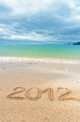 Fototapeta na wymiar Numbers 2012 on tropical beach sand