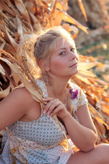 Naklejka premium Young woman in corn haystack