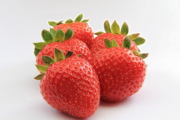 five delicious ripe strawberries on white background