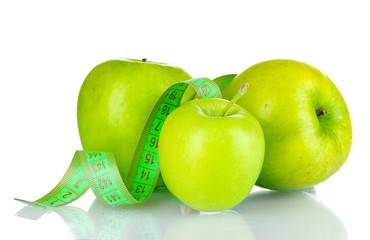 fresh green apples and measuring tape isolated on white