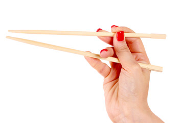 woman's hand and wooden chopsticks isolated on white