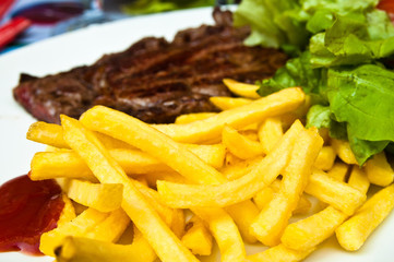 juicy steak beef meat with tomato and french fries