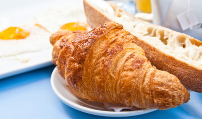 Breakfast with coffee and croissant