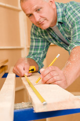 Fototapeta na wymiar Handyman home improvement close-up of measure wood