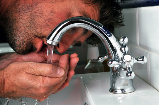 Home buvant au robinet