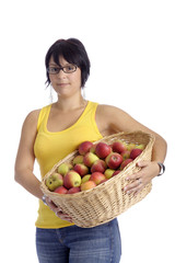 Harvest:young woman with basket full of apples