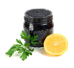 caviar black in a glass jar with lemon and parsley