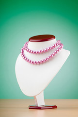 Pearl necklace against gradient background