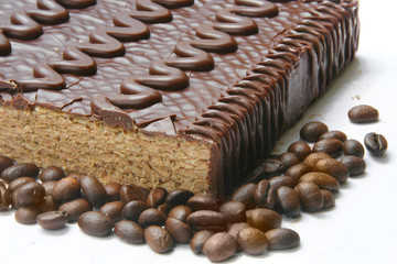 chocolaty  cake and coffee beans close up.