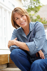 Mid age woman relaxing in garden
