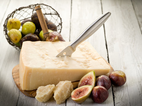 parmesan cheese over cutting board and figs
